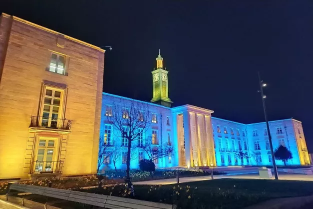 Waltham Forest Town Hall pictured at night on Ukraine Independence Day 2022. The Town Hall is bathed in yellow and blue lights, the colours of the Ukrainian flag.