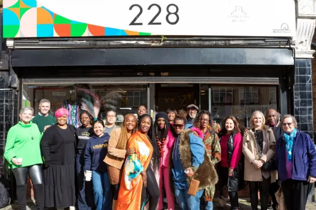 A group of people smiling outside 228 Chingford Mount 