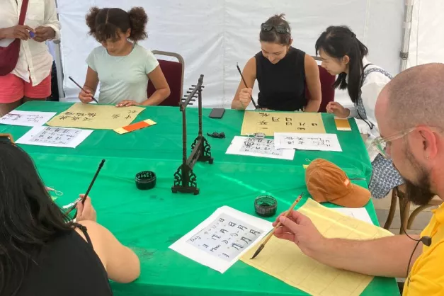 people enjoying a calligraphy class in Fellowship Square