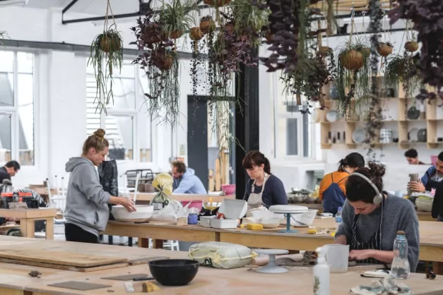 A work shop with people making ceramics