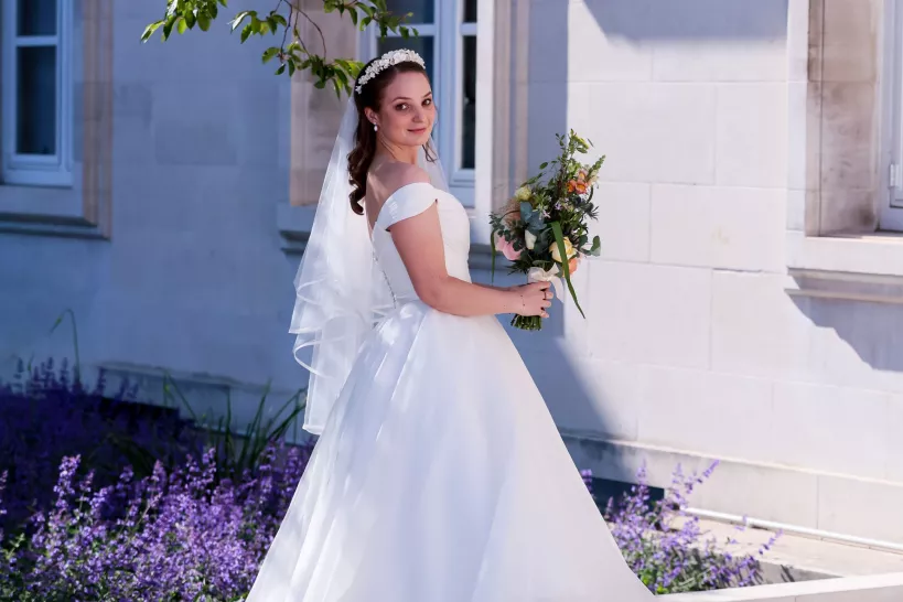 Bride posing in front of Town Hall building