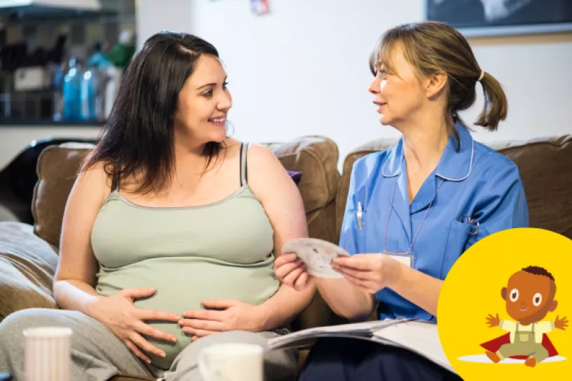 A pregnant woman speaks to a women in scrubs